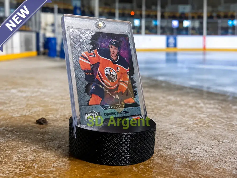 Textured hockey puck card stand displaying a hockey trading card