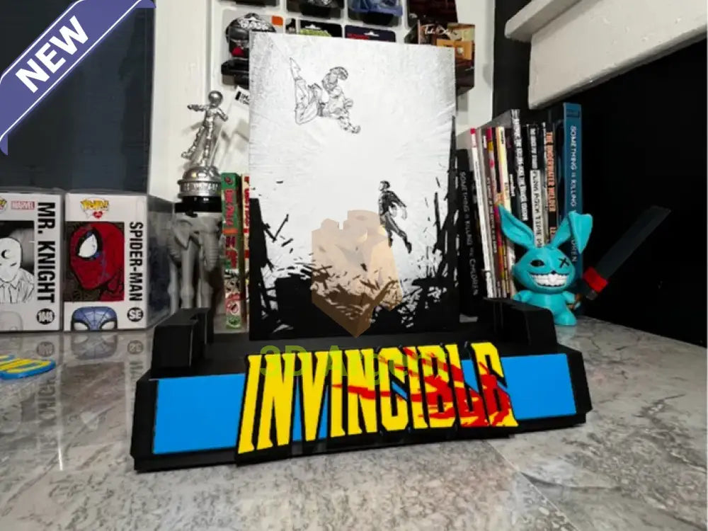 Invincible comic display stand with black and white illustrated backboard and INVINCIBLE wordmark base