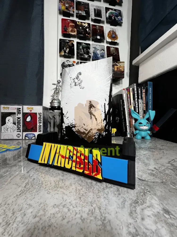 Close-up angled view of the Invincible comic display stand with illustrated backboard and wordmark