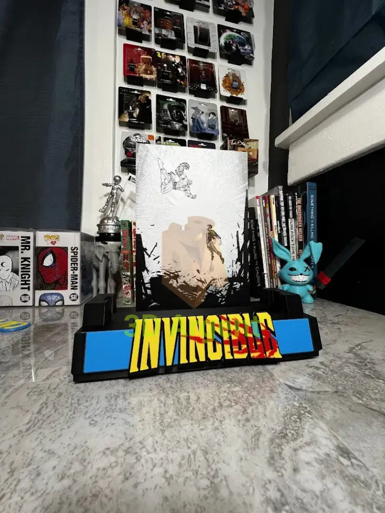 Angled view of the Invincible comic display stand showing the illustrated backboard and wordmark