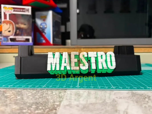 Maestro comic slab display stand, black base with white and green 3D-effect Maestro wordmark, photographed on a workbench