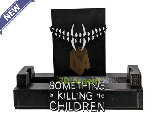 Something is Killing the Children comic display stand with fang backdrop design and wordmark base