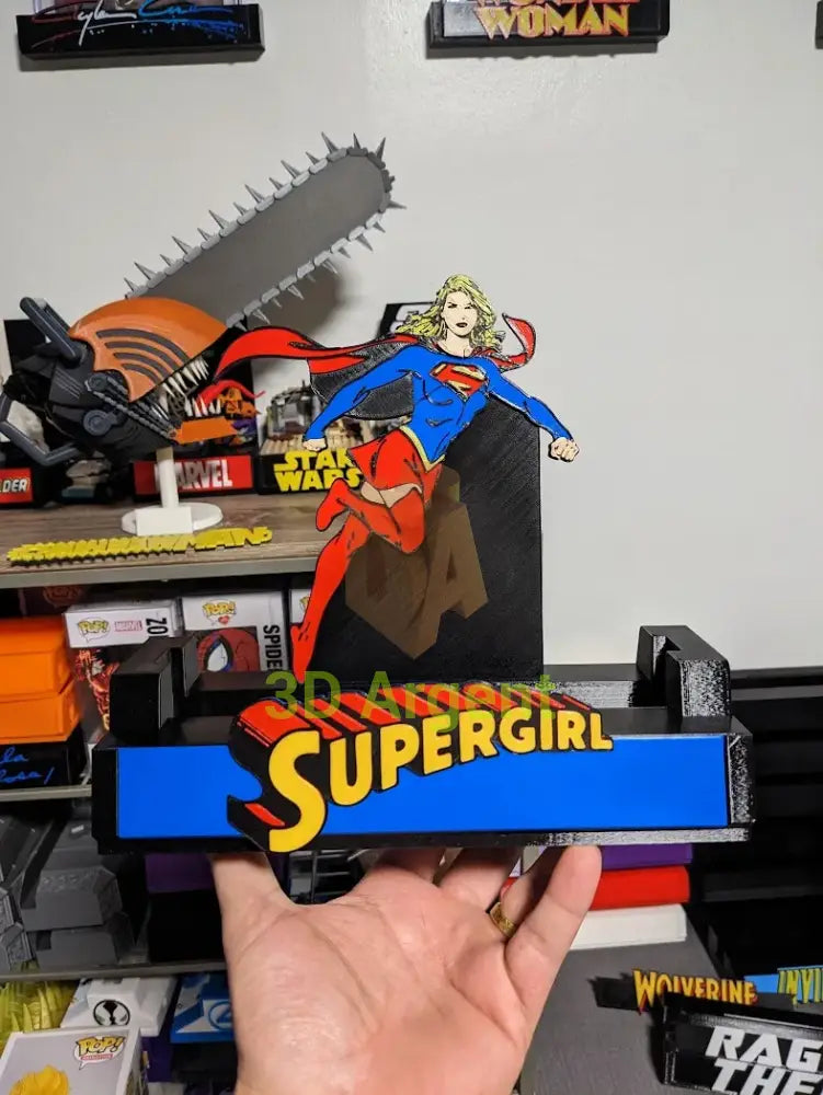 Supergirl comic display stand held in hand, showing scale of the multi-colour PLA print