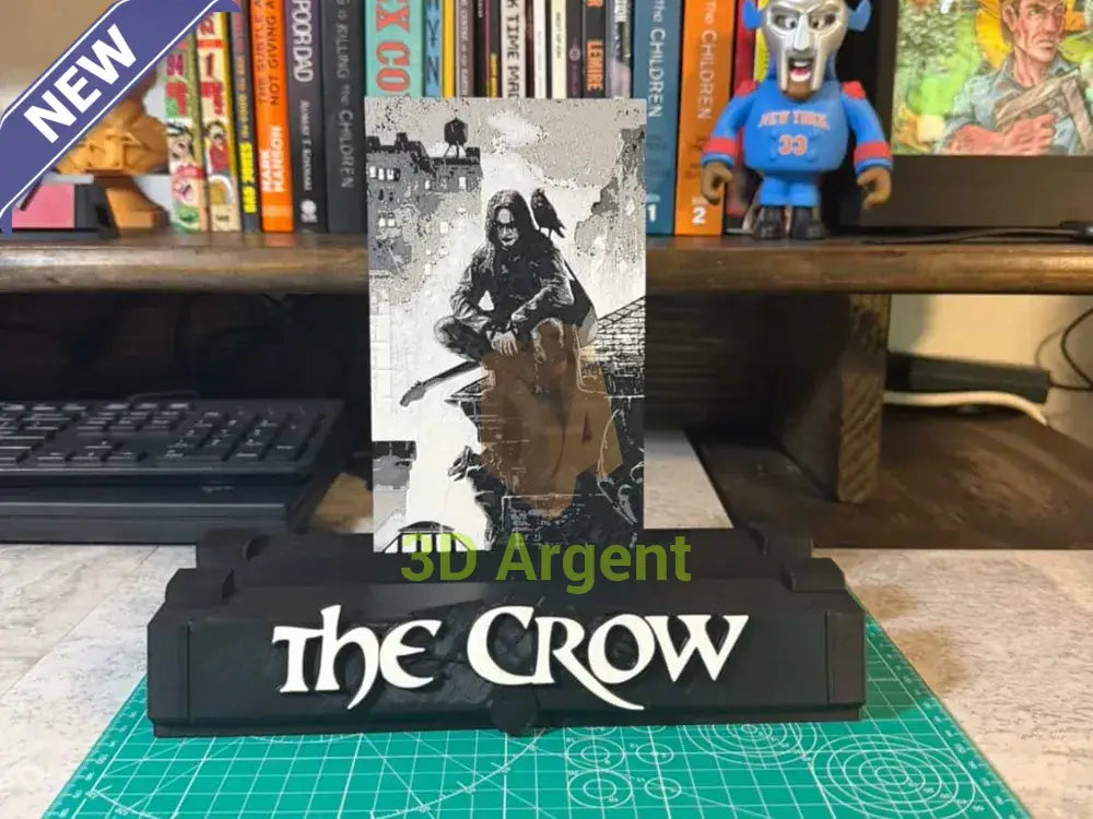 The Crow comic display stand, black base with THE CROW wordmark, holding a graded comic slab