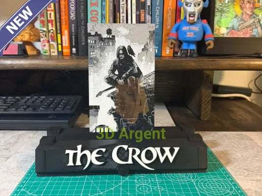 The Crow comic display stand, black base with THE CROW wordmark, holding a graded comic slab