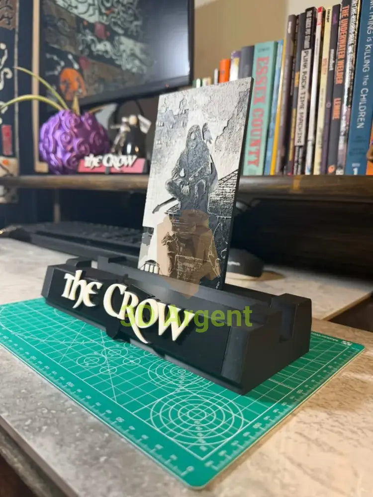 Angled view of The Crow comic display stand with THE CROW wordmark base and graded comic slab in place