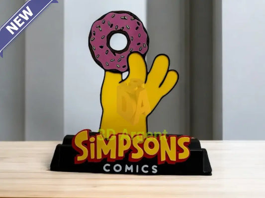 The Simpsons comic display stand with multi-colour hand-and-donut design and SIMPSONS COMICS wordmark base