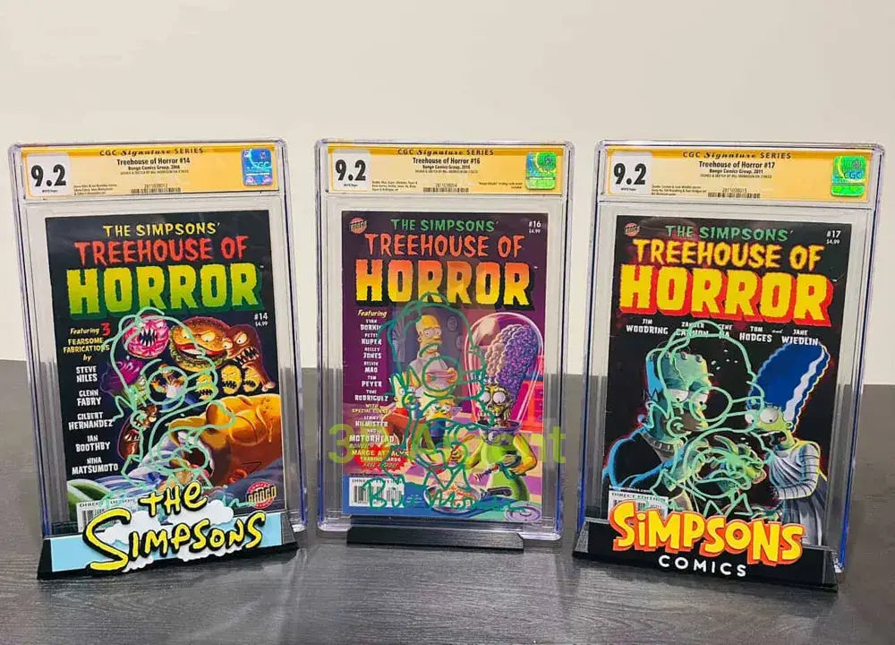 Three Simpsons comic display stands in use, each holding a CGC-graded slabbed comic